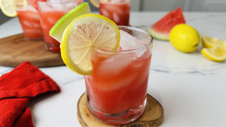 glass of watermelon lemonade with fruit garnish