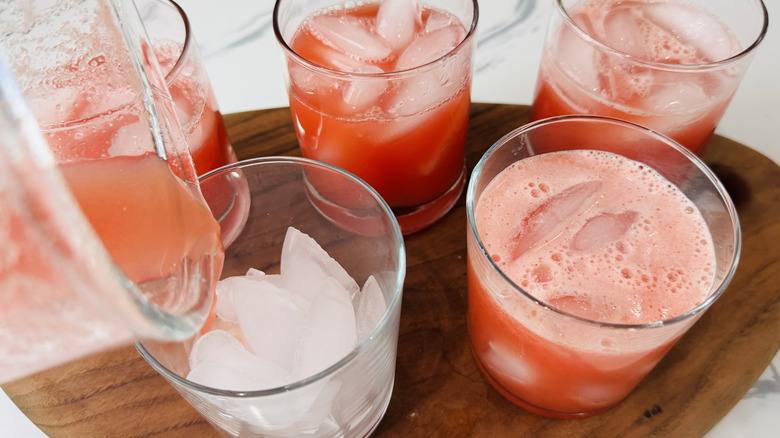 pouring watermelon lemonade in glasses