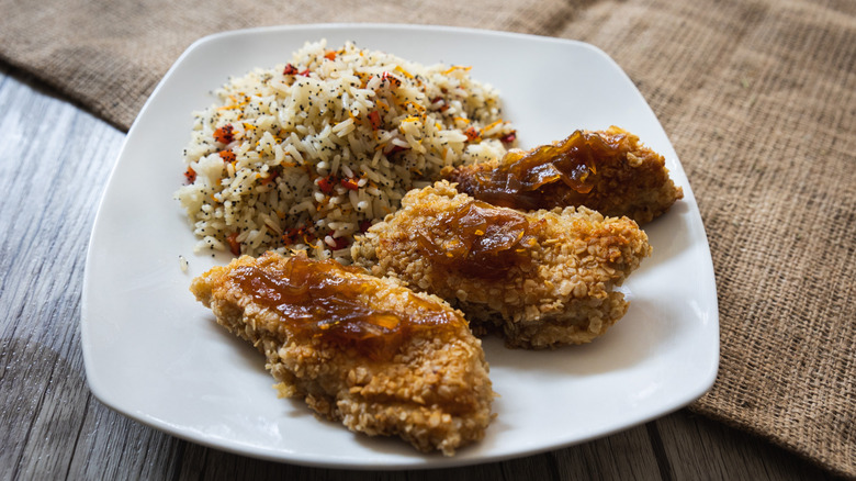 Crispy oatmeal chicken served with rice on a plate