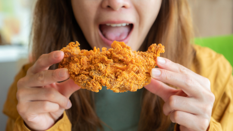 Woman holding crispy fried chicken