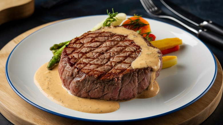 A center-cut steak slathered in sauce
