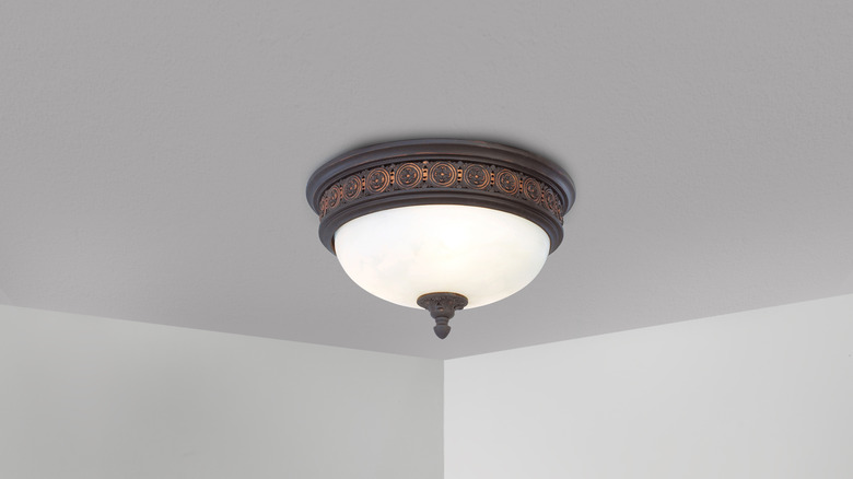 mounted ceiling light fixture with a dated look