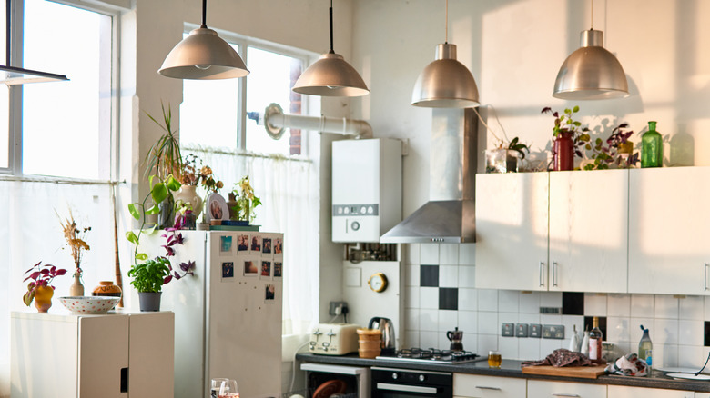 pendant lights hanging in an outdated kitchen