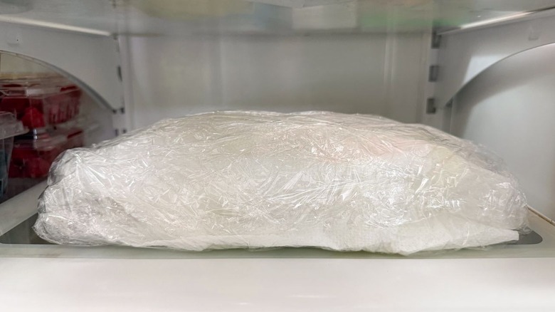 Lettuce cups wrapped in plastic in refrigerator