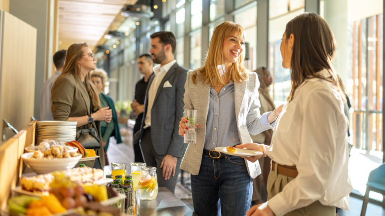 People smiling and talking at a buffet
