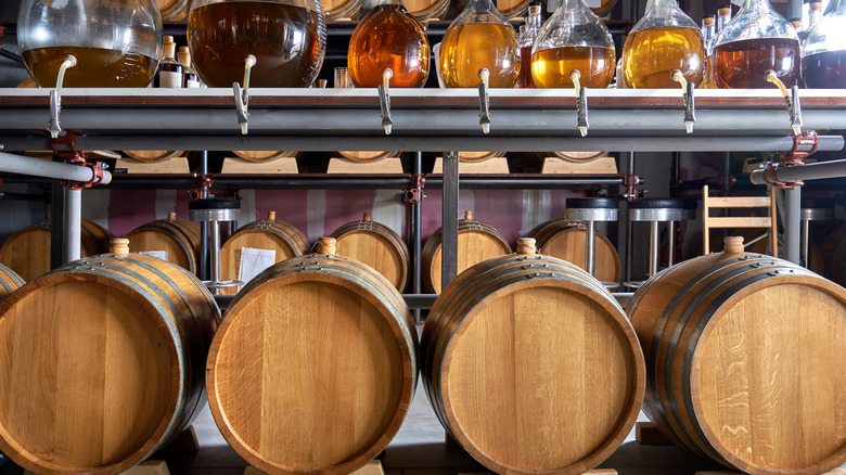 Whiskey aging process with barrels and jugs