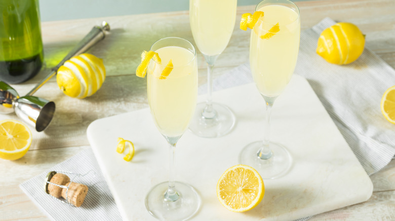 French 75 cocktails in champagne flutes with supplies used to make them