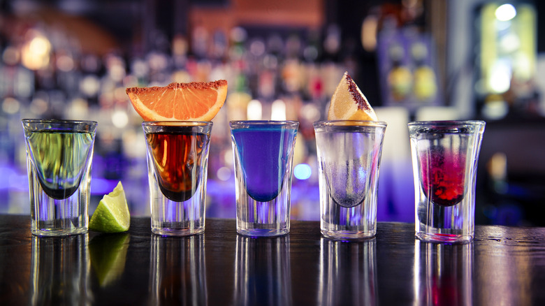 Lineup of colorful shots on a bar