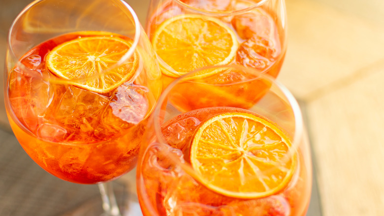 Overhead view of Aperol spritz cocktails with orange slices