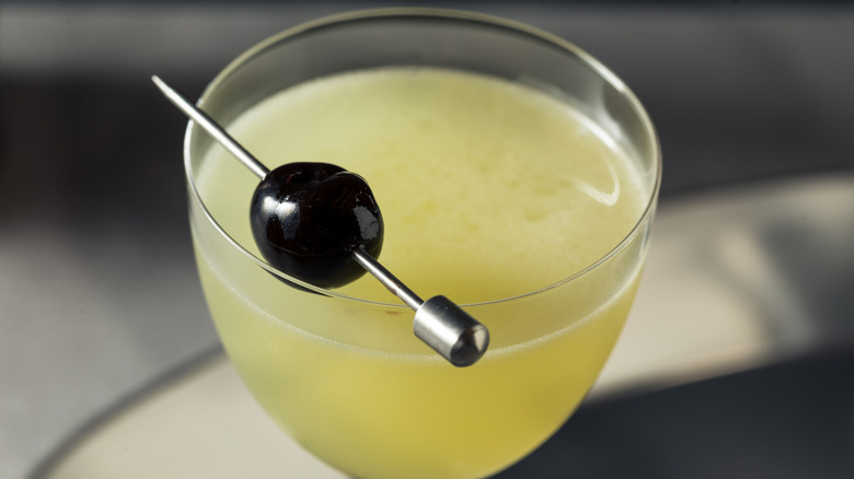 Close-up of a last word cocktail with a Luxardo cherry garnish