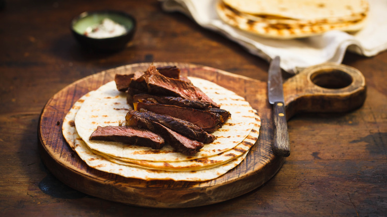 sliced skirt steak and tortillas