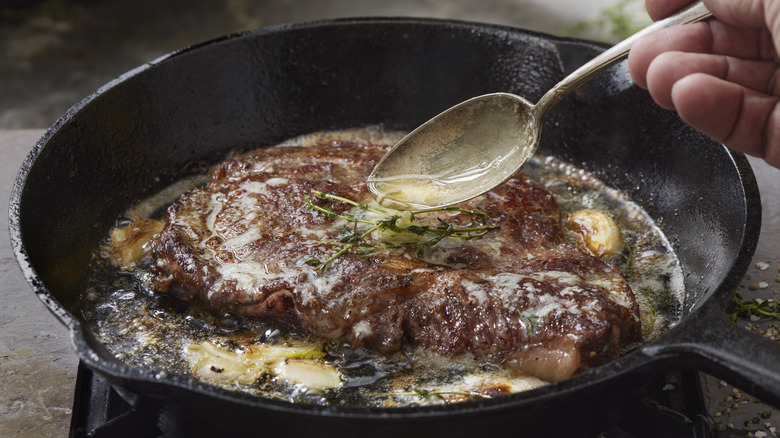 butter basting steak with thyme