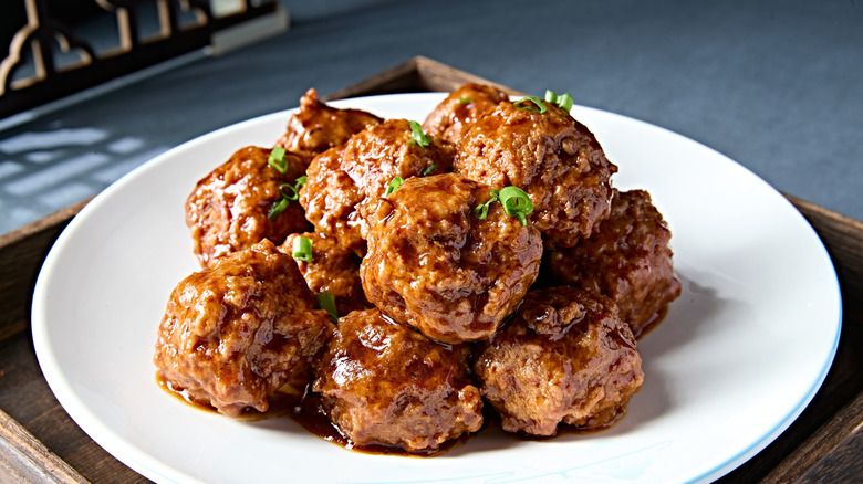 succulent cooked meatballs stacked on a plate