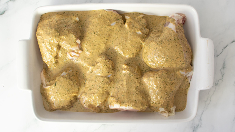 Chicken in casserole dish coated in marinade