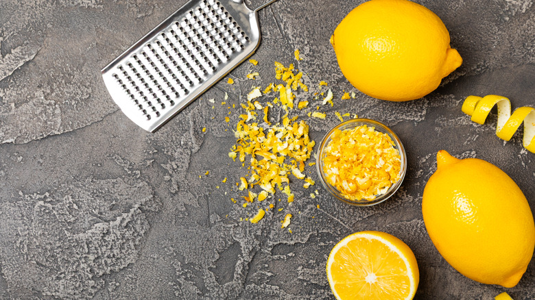 Lemon fruit zest on a gray surface.