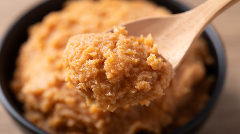 Traditional Japanese miso paste in a wooden spoon.