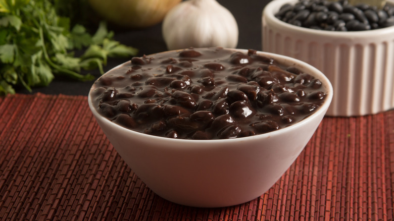 A white bowl of black beans.