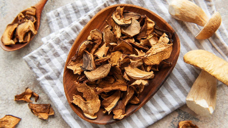 A wooden plate of dried mushrooms.