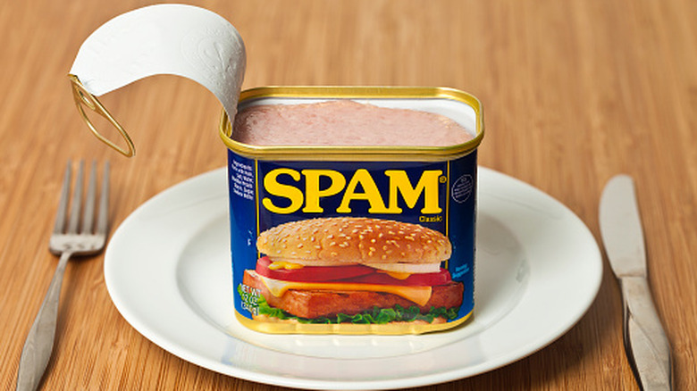 An open can of Spam on a plate.