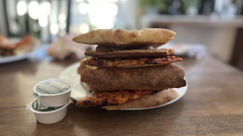 Stack of Papa Johns pizza crusts