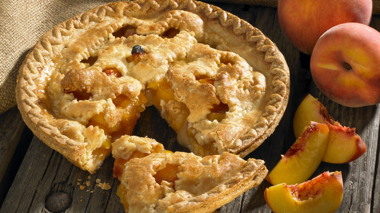 peach pie with slice taken out 