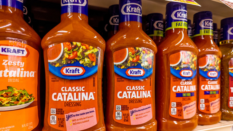 A row of Kraft Classic Catalina Dressing bottles lined on a grocery store shelf