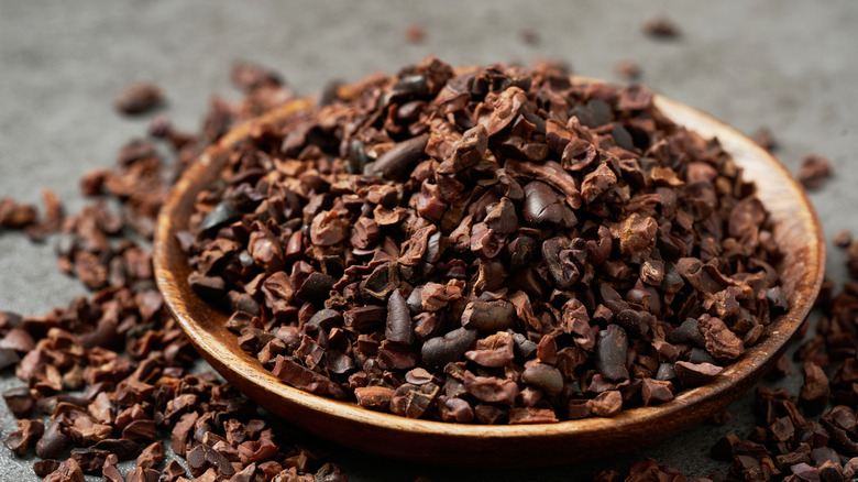 Cocoa nibs overflowing in a bowl