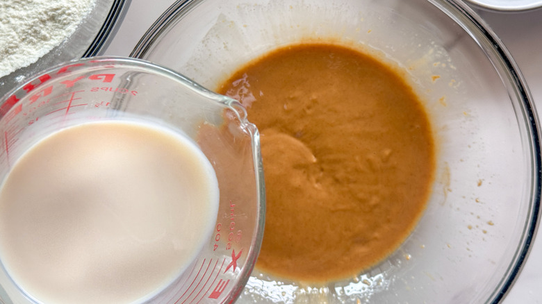 Milk pouring into bowl with peanut butter