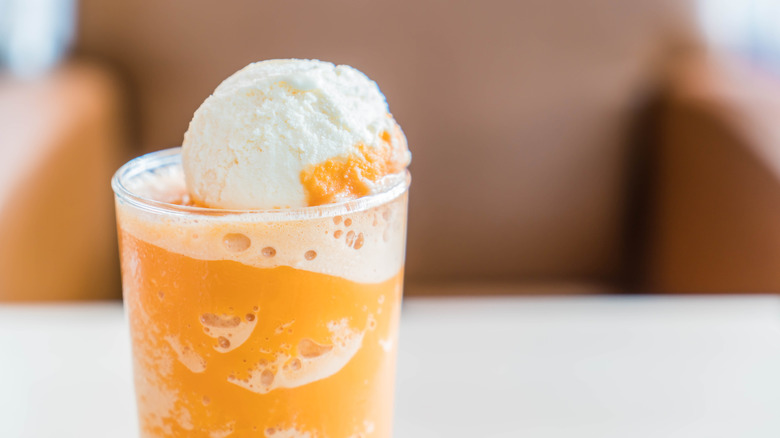 A pumpkin flavored rink topped with ice cream.