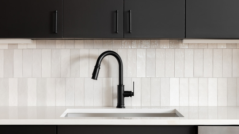 white kitchen backsplash with black cupboards