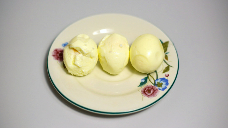 Three results of peeling eggs with a spoon