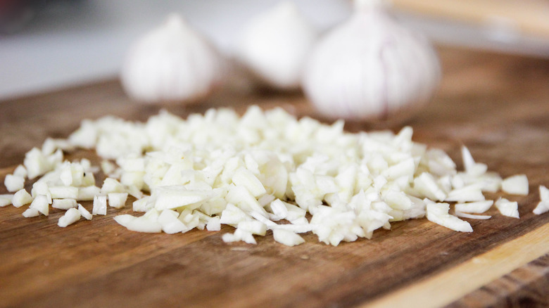 Chopped garlic on a wooden cutting board