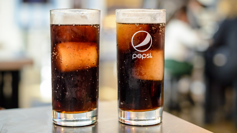 Two glasses of soda, one featuring the Pepsi logo