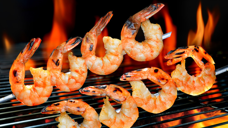 Shrimp skewers over a flame