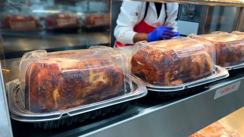 Rotisserie chickens in a warmer at a store
