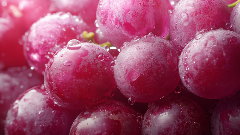 close-up of grapes, onions and spices in pickling liquid