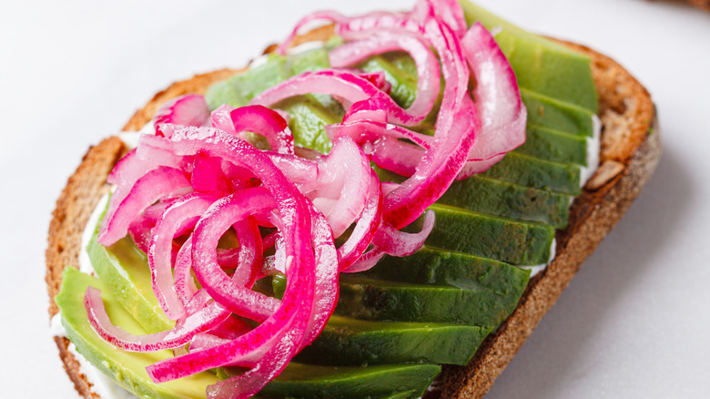 Pickled red onions on avocado toast
