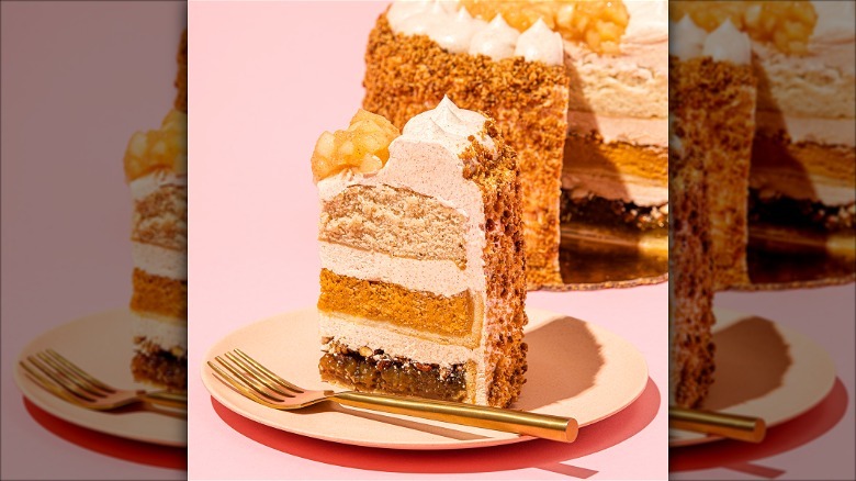 Slice of PieCaken on pink background.