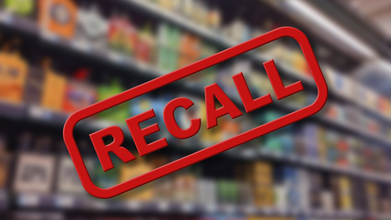 Recall stamp graphic over grocery store shelves in background.