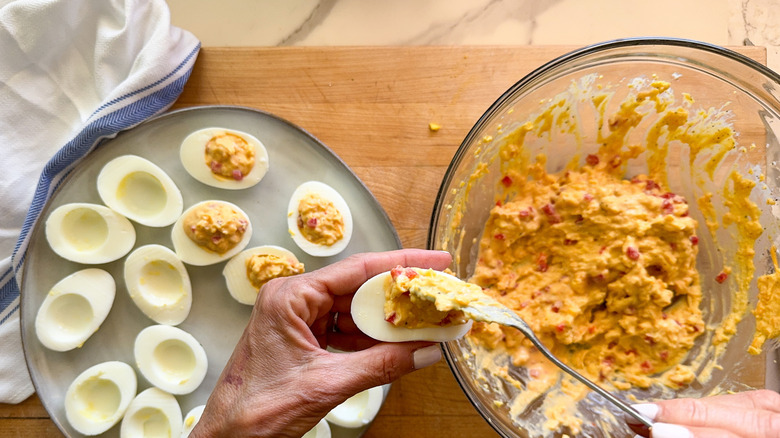 filling deviled eggs with pimento mixture