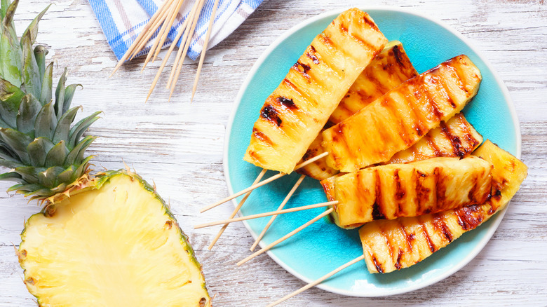 Skewered grilled pineapple pieces in a plate