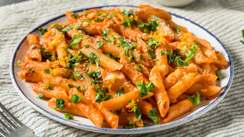 Penne pasta in blush sauce with herbs and cheese