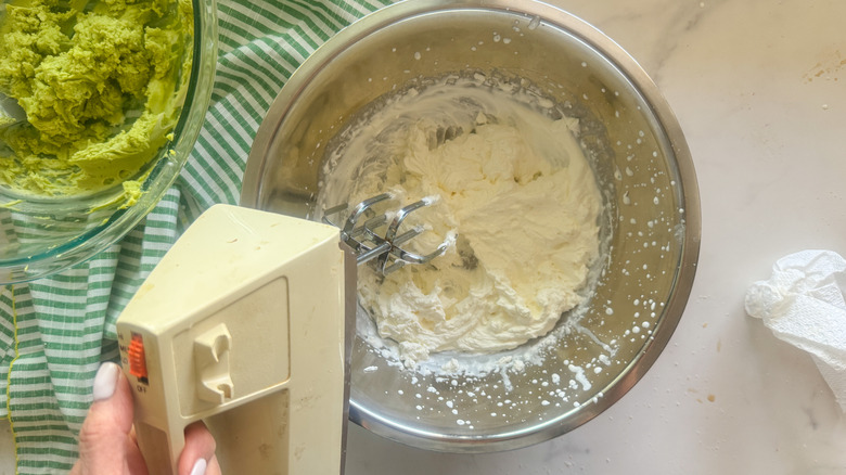 hand beating the whipped cream