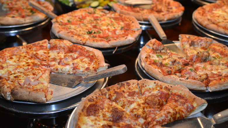 Freshly cooked pizza laid on a pizza buffet