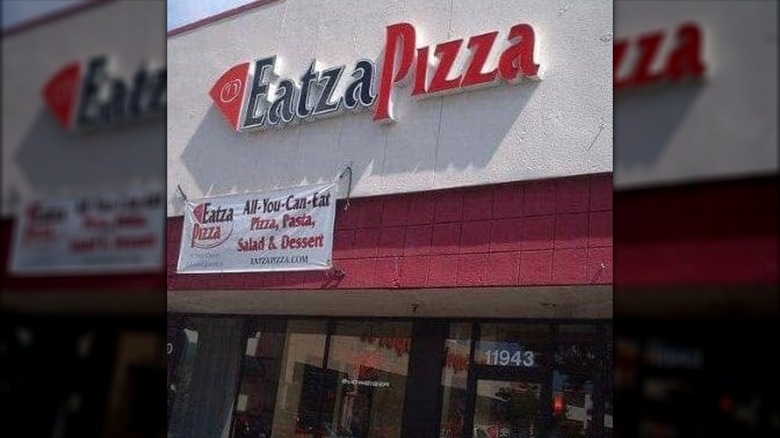 Exterior of Eatza Pizza storefront with a banner offering all-you-can-eat pizza, pasta, salad, and dessert.