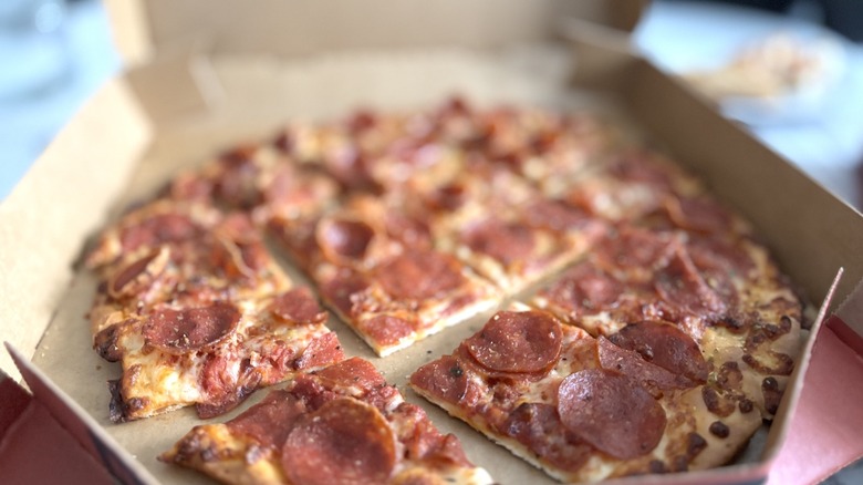 Pizza Hut tavern crust pepperoni pizza with faded background