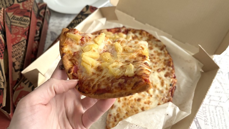hand holding Pizza Hut gluten-free crust