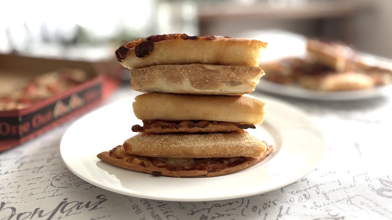 stack of Pizza Hut crusts on a plate