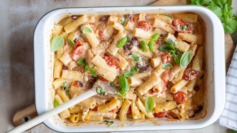 Baked feta, spinach, and tomato rigatoni in sauce.