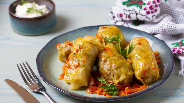 Polish cabbage rolls arranged on a plate with garnishes.